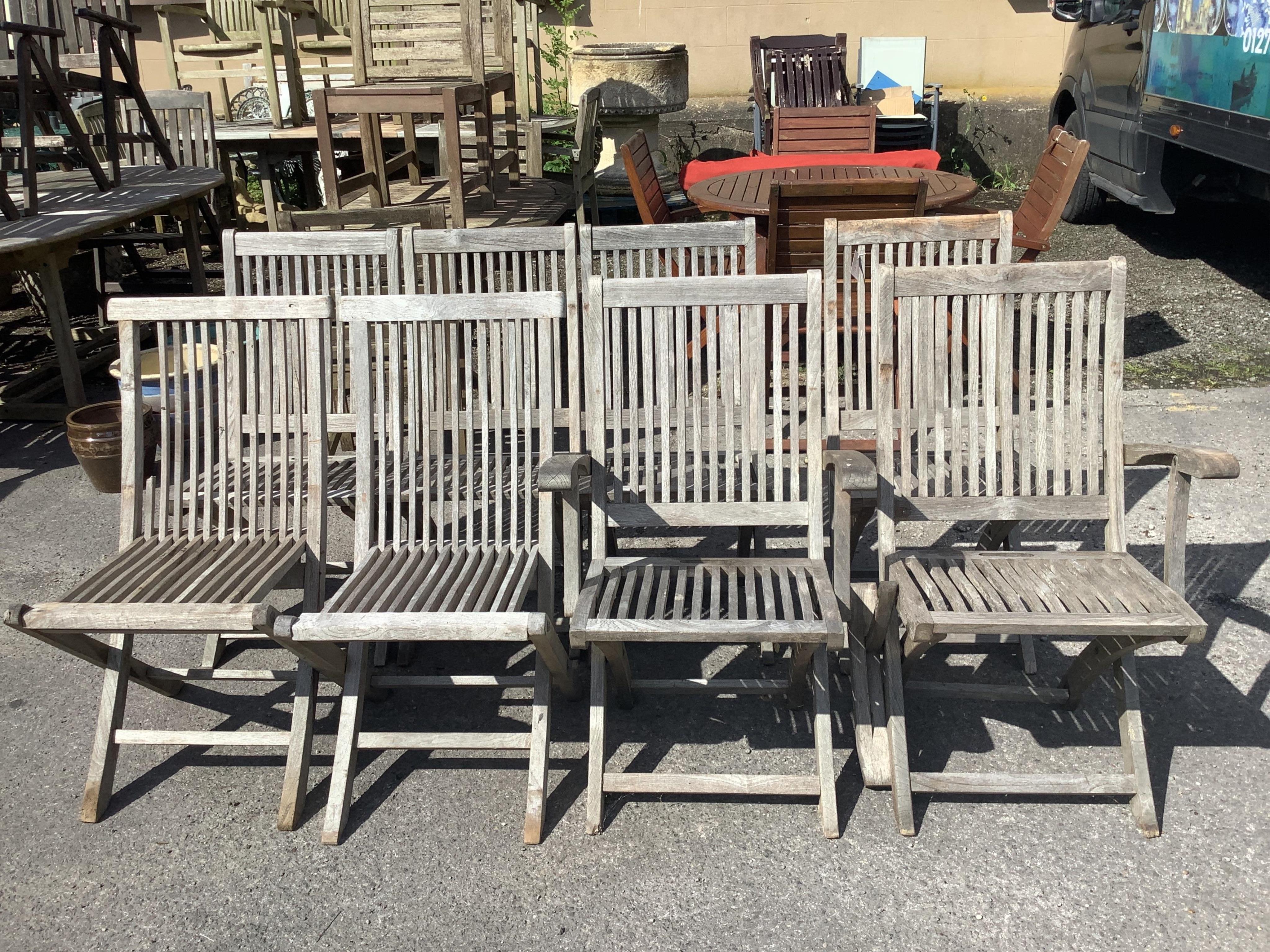 A set of eight (six plus two) weathered teak folding garden chairs, two with arms. Condition - good